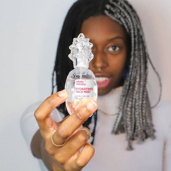 person holding rebels refinery hydrating mist