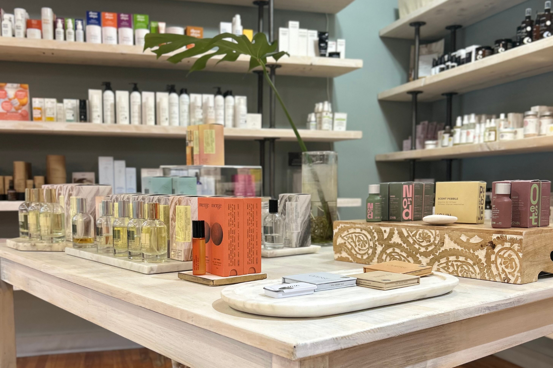 Display of Truth Beauty's fragrance and skincare sections on shelves and a table in store. Featuring Merge, Lohn and DedCool.