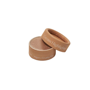 Beige cream highlighter with lid on a light beige background