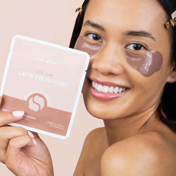 Woman holding a package of Iced Chai Latte eye patches mask with a beige background featured in Cocoa Dreams Skincare Treats Set