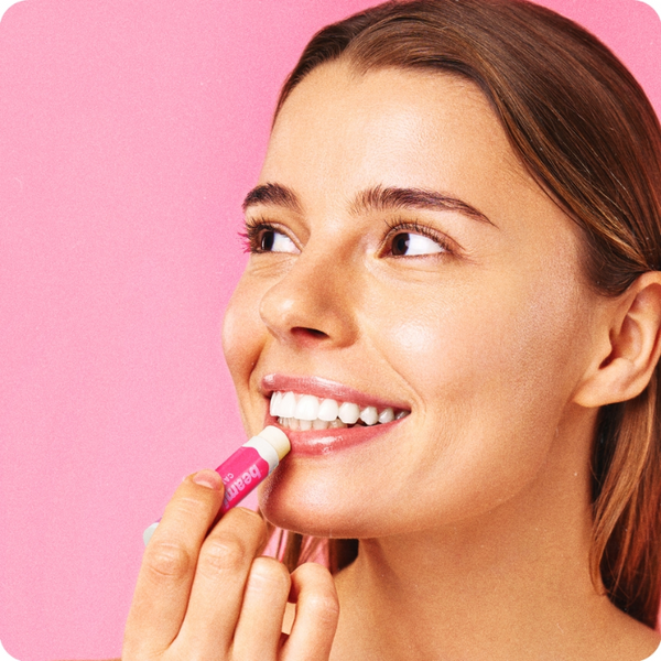 Person applying Beamie Balm Cherry Crush lip balm