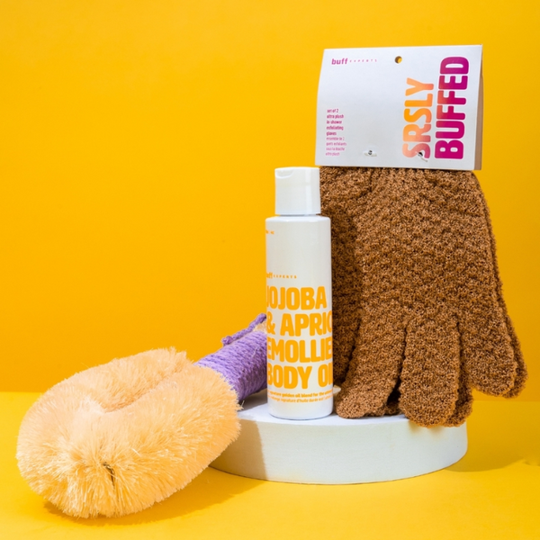 Bottle of Buff Expert Jojoba & Apricot Emollient Body OIl with exfoliating Mitts & Dry Brush