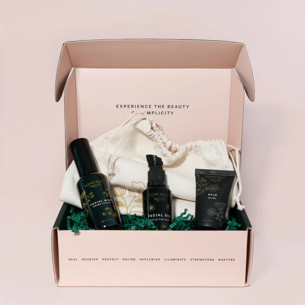 Skincare product set in a box with a pink background