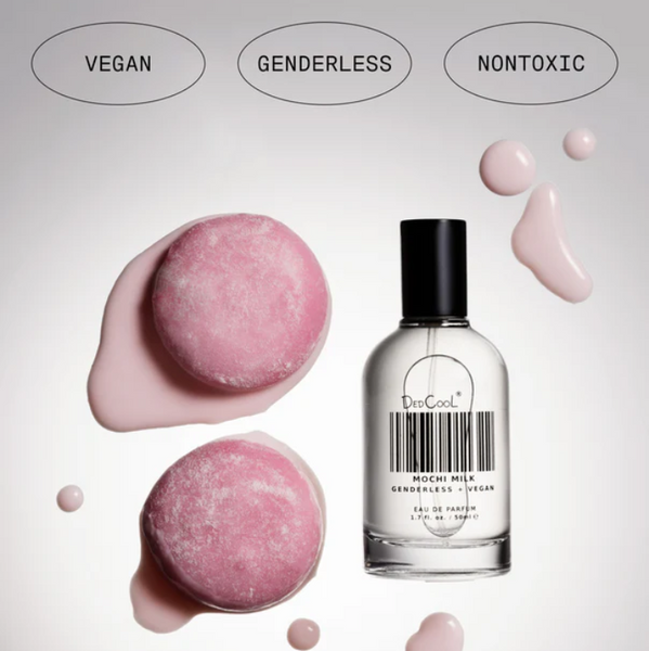 Bath bombs and a perfume bottle with 'vegan', 'genderless', and 'nontoxic' labels on a light background.