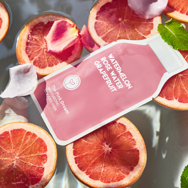 Watermelon Rose Water Grapefruit Mask on a background of sliced grapefruits, featured in Strawberry Sweets Skincare Treats Set