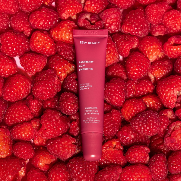 ESW Beauty raspberry lip treatment tube surrounded by raspberries