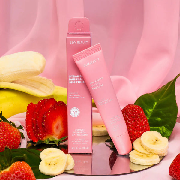 Strawberry Banana Smoothie Lip Treatment with strawberries and bananas on a pink background