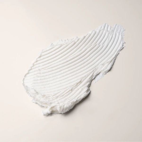 White textured swatch of the body wash concentrate by Everist on a light beige background