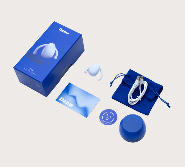 light blue Eva II Vibrator by Dame product packaging with accessories on a light gray background
