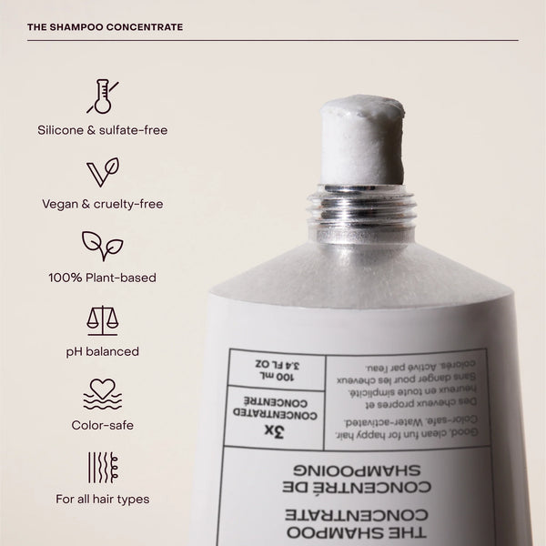 Shampoo concentrate bottle with certification icons on a beige background