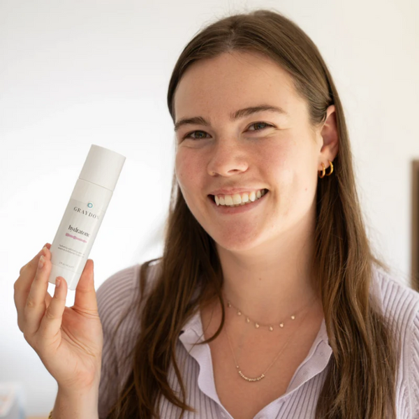 Person holding a bottle of Graydon Hydratone Exfoliating Essence