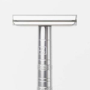 Silver safety razor on a white background