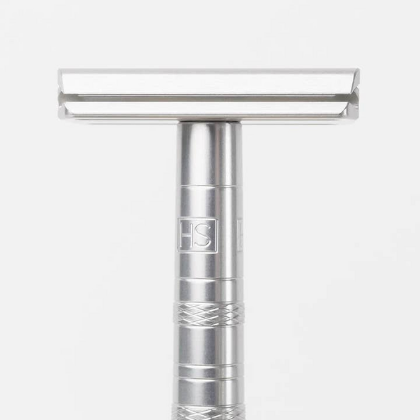 Silver safety razor on a white background