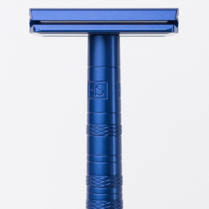 Blue safety razor on a white background