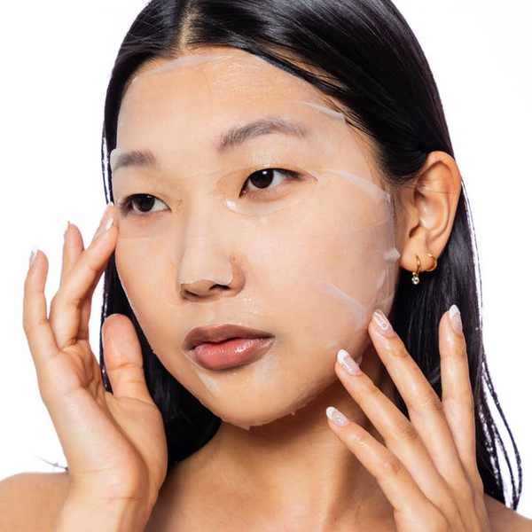 Woman applying makeup with a focus on her face