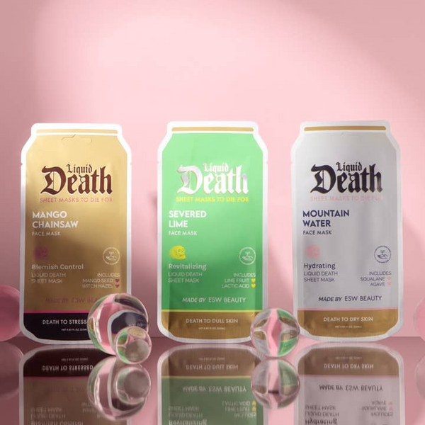 Three 'Liquid Death' face mask cans on a pink background