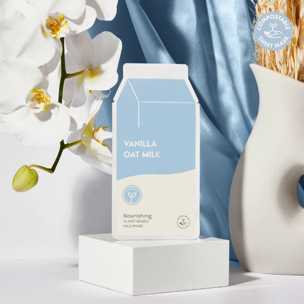 Vanilla oat milk Nourishing mask package with white orchid and blue fabric in the background - featured in Cocoa Dreams Skincare Treats Set