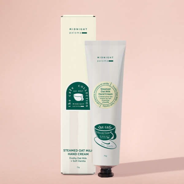 Steamed Oat Milk Hand Cream with packaging on a pink background