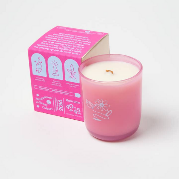 Pink candle with a matching pink box on a white background