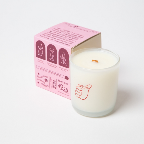 White candle with pink packaging on a white background