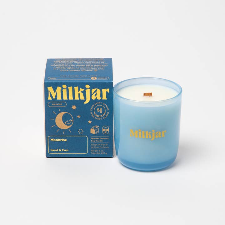 Blue Milkjar candle and packaging on a white background