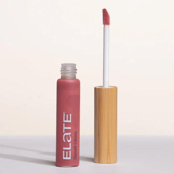 Lip gloss in shade Good Gloss Oracle from Elate with wooden applicator on a white background