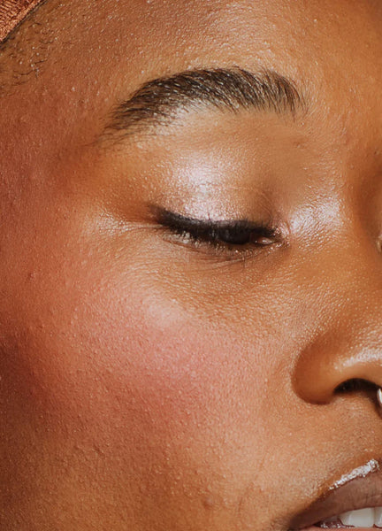 Close-up of a person's face with closed eyes, focusing on the their eyeliner.