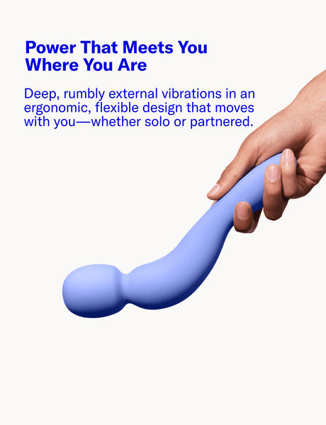 Blue Com External Wand Vibrator by Dame held by a hand with promotional text on a white background about how it is an ergonomic device 