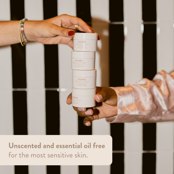 Hands holding a stack of mini paume overnight hand and foot hydrating mask