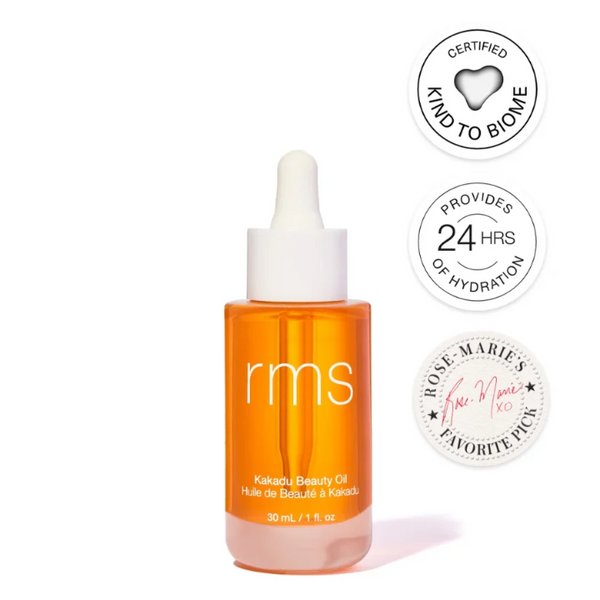 Orange bottle of RMS Beauty oil with certification logos on a white background