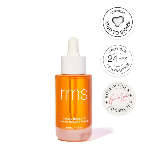 Orange bottle of RMS Beauty oil with certification logos on a white background