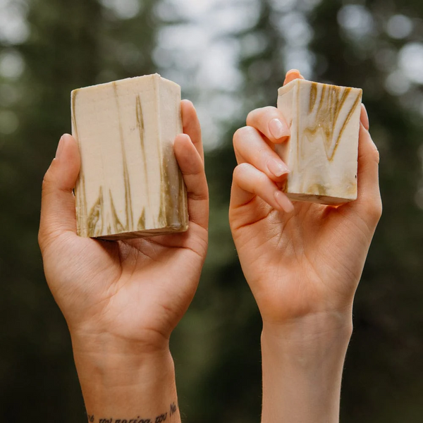 People holding bars of Rocky Cold-Pressed Soap