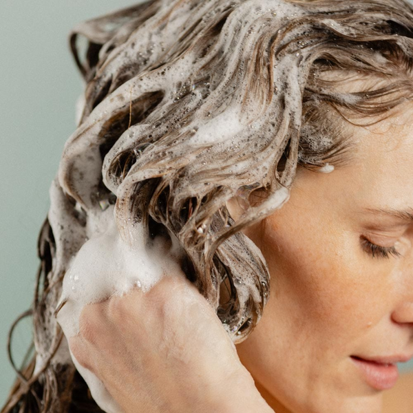 Person washing their hair with Rocky Wild Kindness Shampoo