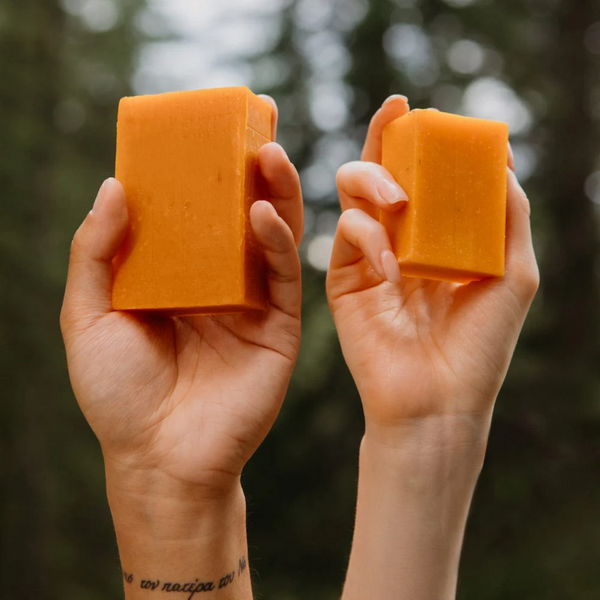 people holding bars of Rocky cold pressed Juicy Orange soap