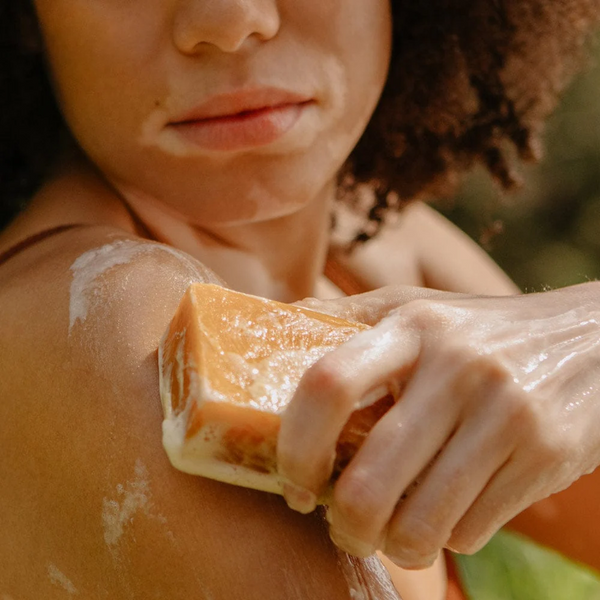 Person using Rocky Juicy Orange cold pressed bar soap
