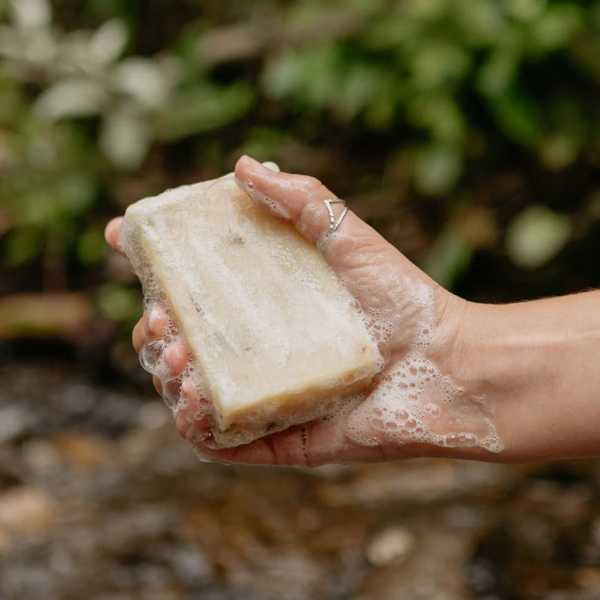 Person lathering Rocky cold pressed lemongrass bar soap