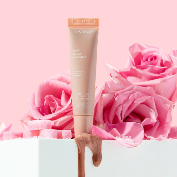Rose Sugar Smoothie Lip Treatment tube with pink roses on a light pink background