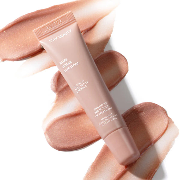 Tube of 'Glow Beauty' lip treatment with swatches of the product on a white background