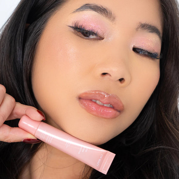 Close-up of a woman holding Rose Sugar Smoothie Lip Treatment