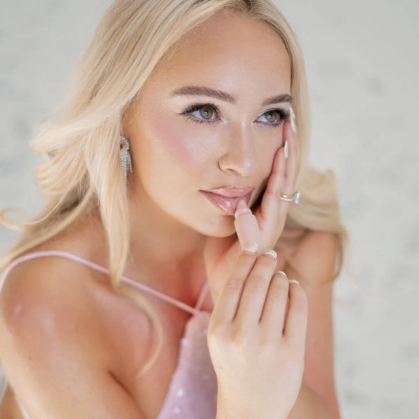 Woman applying Rose Sugar Smoothie Lip Treatment with a neutral background