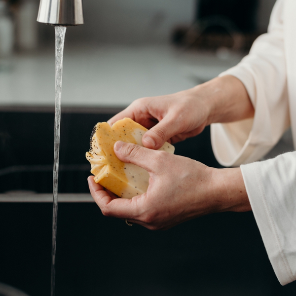 person washing their hands with Soak Bath Co. Citrus Poppyseed Bar Soap made in Canada