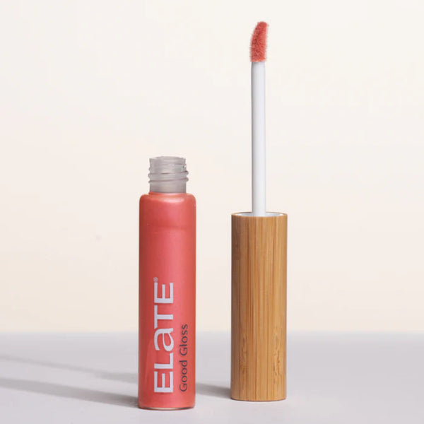 Lip gloss from Good Gloss in shade Solara with wooden applicator on a white background