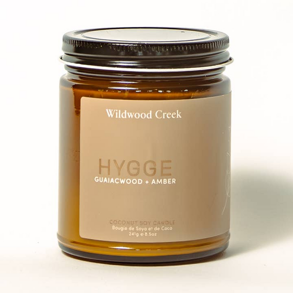 Candle jar with 'Wildwood Creek' label on a white background Hygge