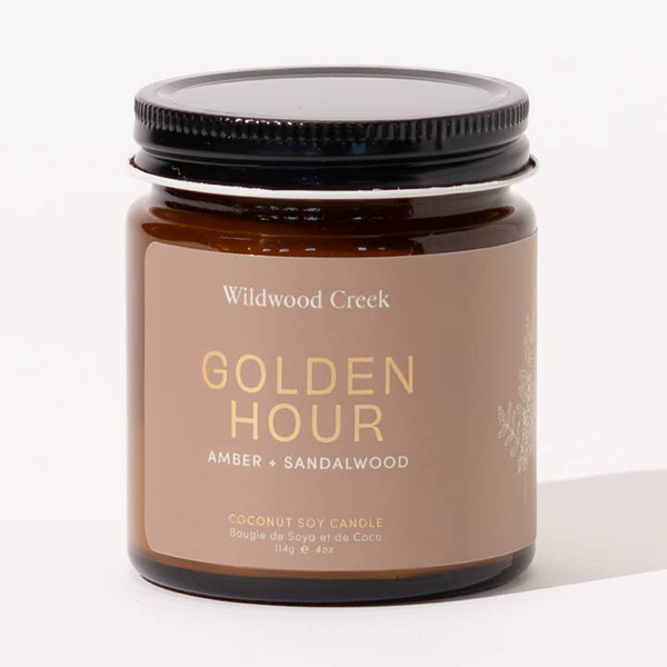 Candle jar labeled 'Golden Hour' by Wildwood Creek on a white background