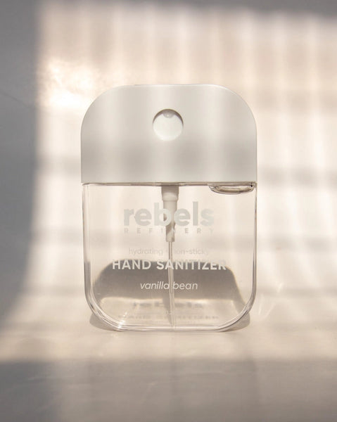 Hand sanitizer bottle with 'rebel's' branding on a neutral background
