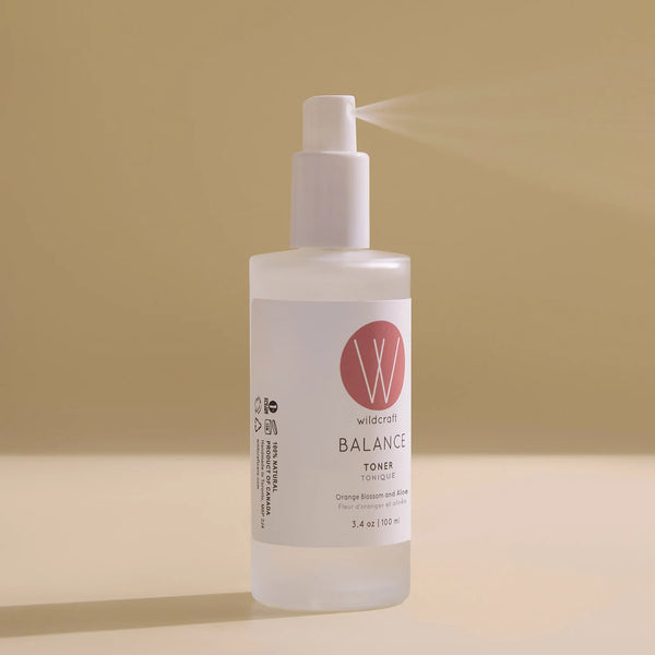 White bottle of 'Balance Toner' with a red logo on a beige background