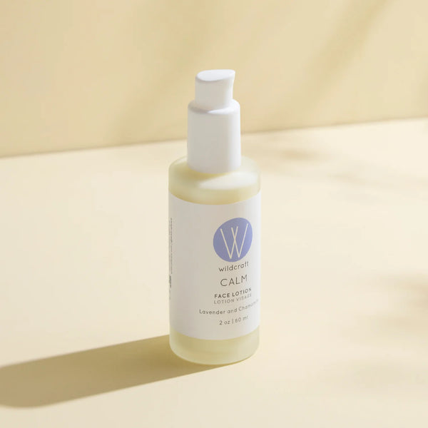 Bottle of Wildcrafts Calm Face Lotion on a beige background