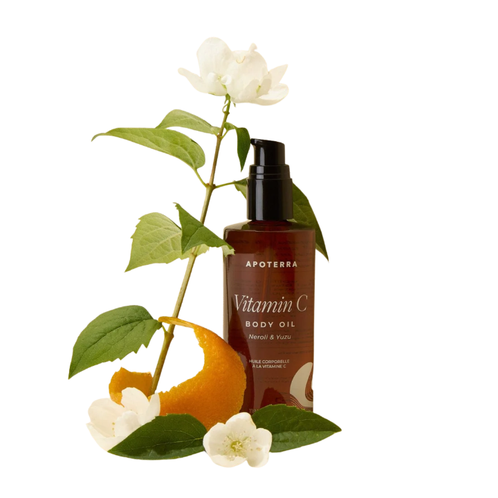 Apoterra Vitamin C body oil bottle with orange, leaves, and flowers on a white background