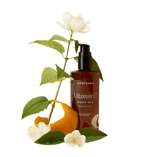 Apoterra Vitamin C body oil bottle with orange, leaves, and flowers on a white background