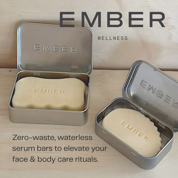EMBER wellness zero-waste serum bars in metal tins on a wooden background